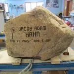 A rock with the name of jacob adam hahn engraved on it.