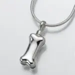 A silver dog bone pendant on a chain.