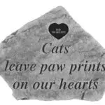 A rock with the words cats leave paw prints on our hearts.