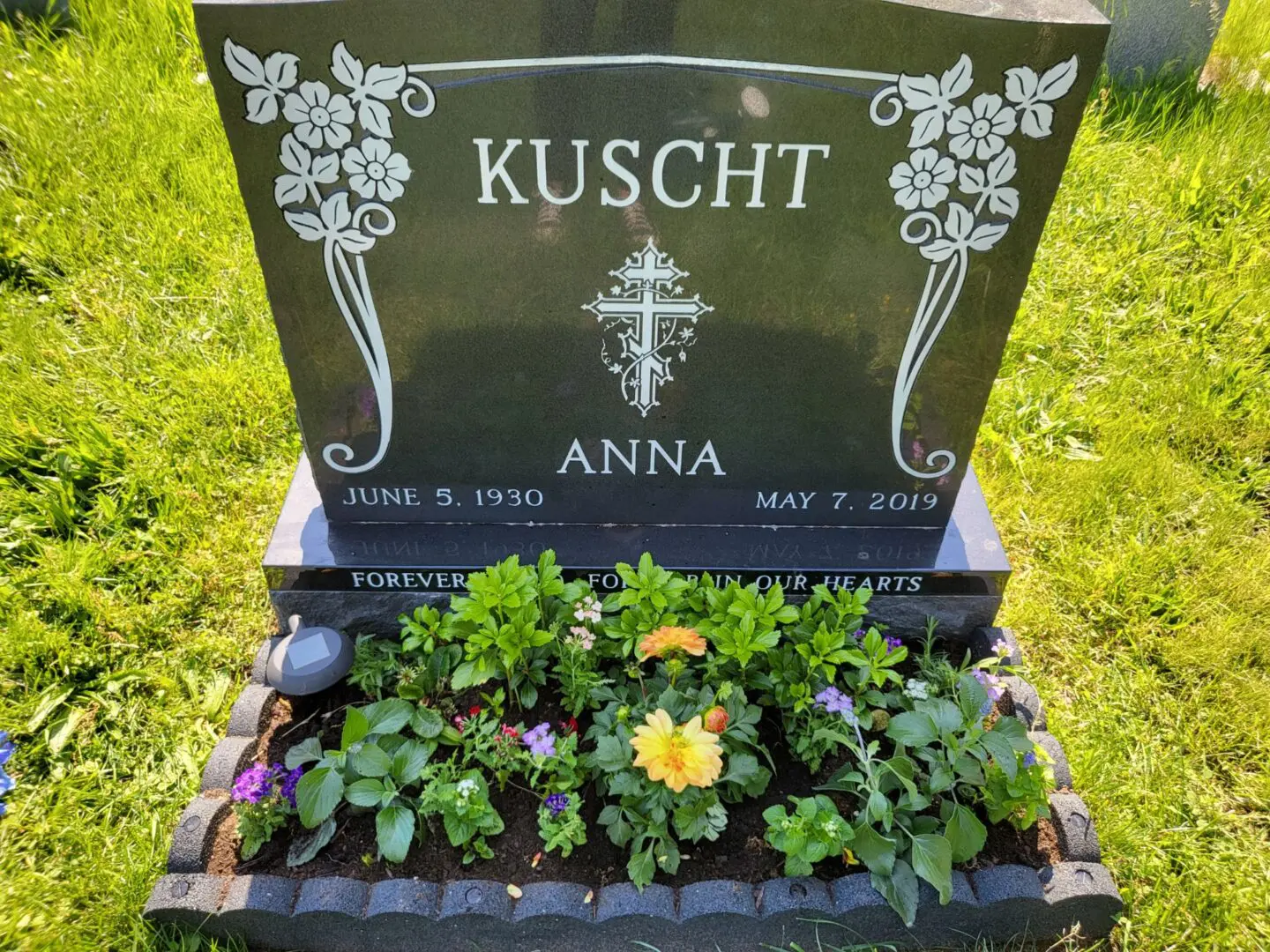 A grave with flowers growing out of it.