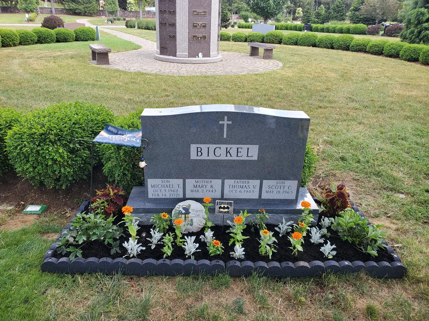 A grave with flowers and plants in it.