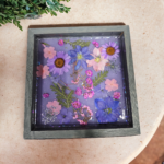 A square shaped tray with flowers on it.